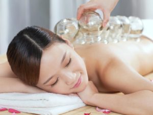 Young woman has Chinese medicine cupping on her back